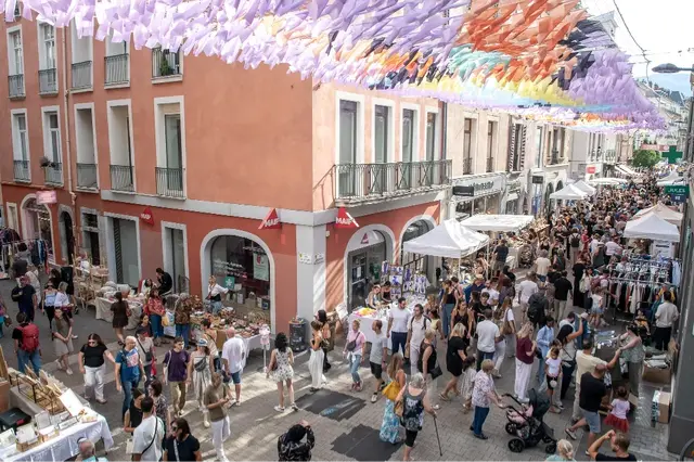 La rue de Bonne est remplie de passants et de stands de commerces